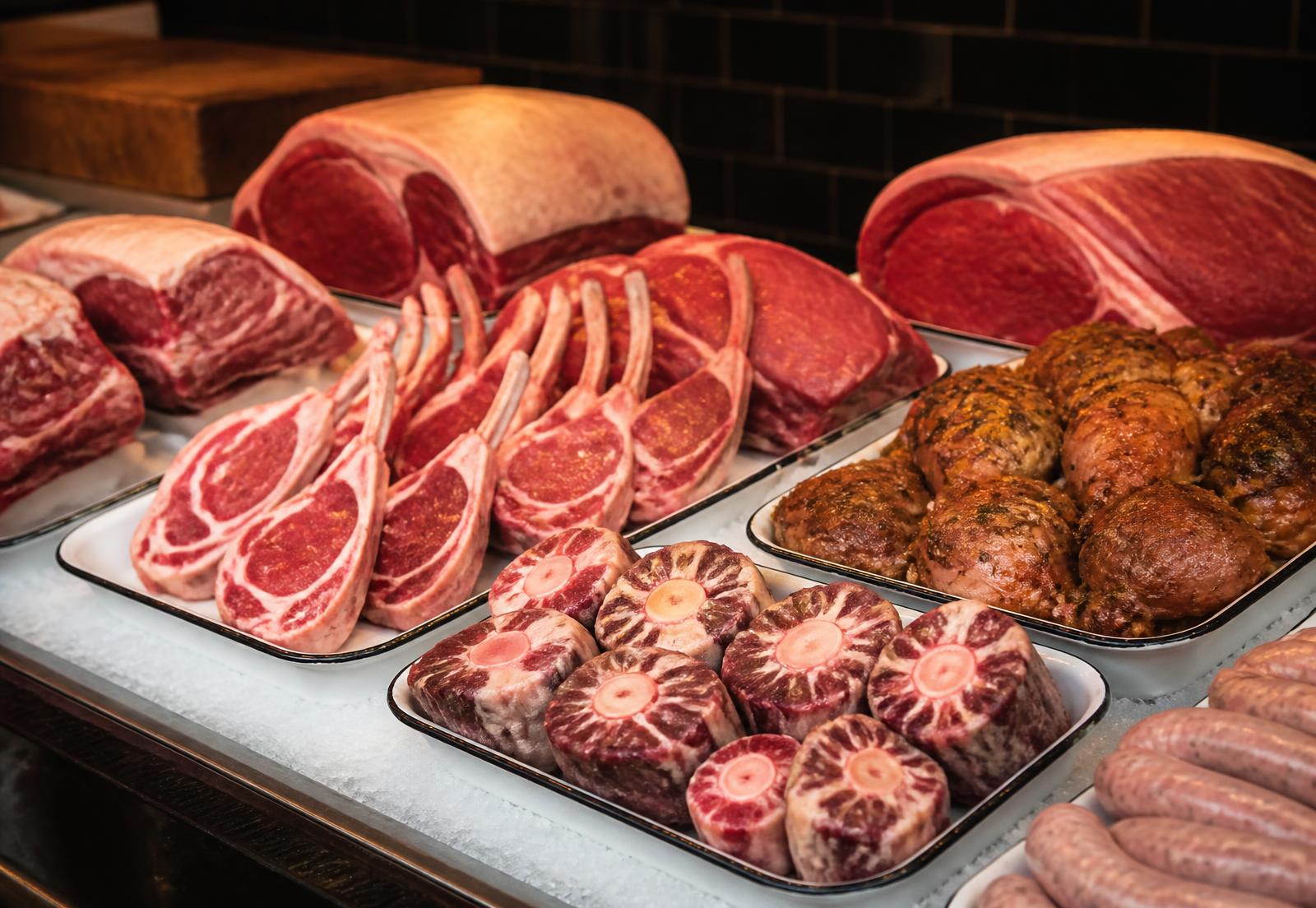 Fresh cuts of beef, lamb, oxtail and seasoned chicken on trays at Lando's Family Butchers counter